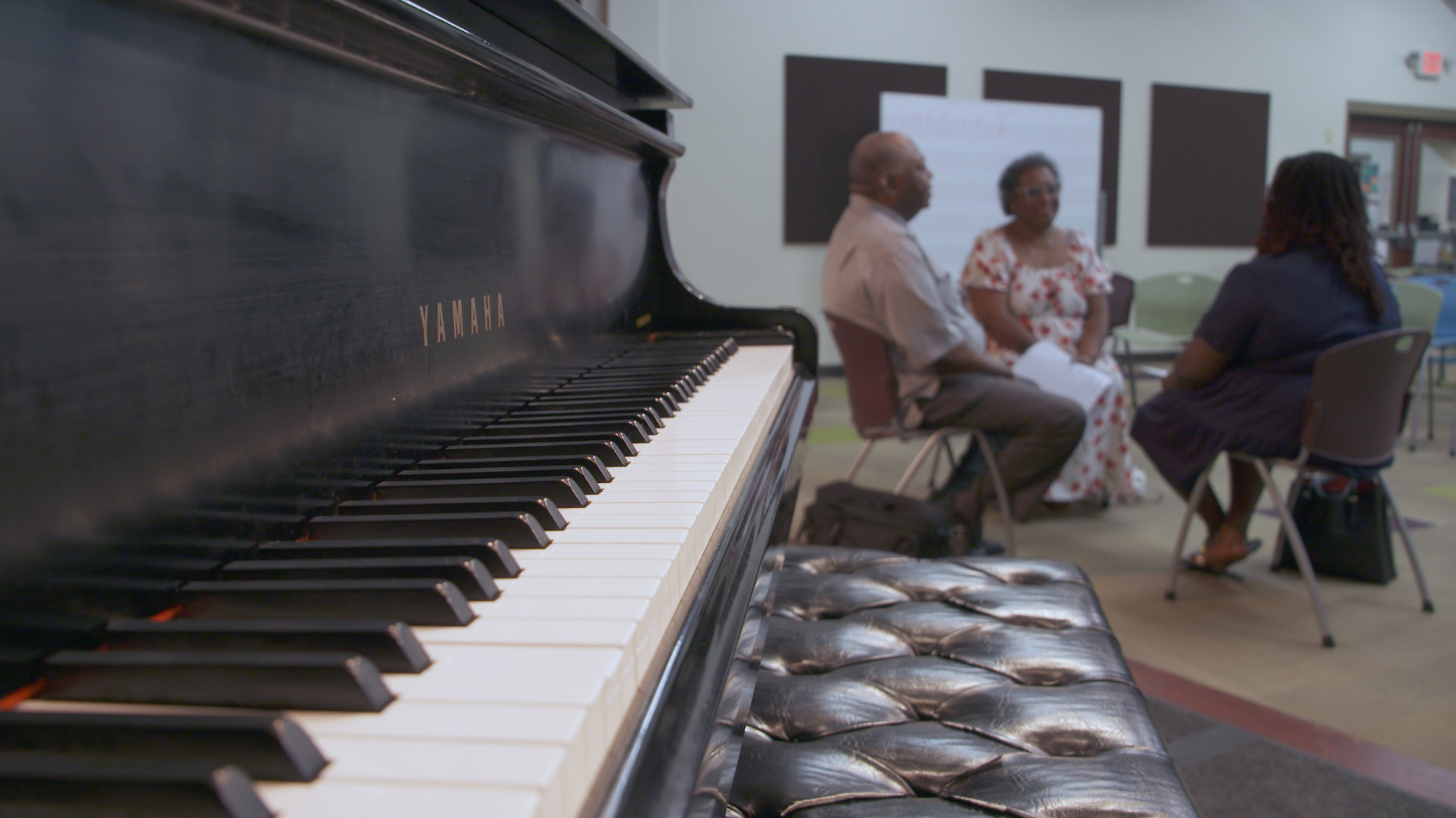 (Left to Right) Music Director Carl Clomon, Program Coordinator Gale Cannon, and Program Director Shana Moses have a meeting about the Amazing Grace Chorus at Walker West Music Academy in Art + Medicine: Healthy Aging.